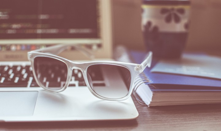 Photo of sunglasses sitting on a laptop